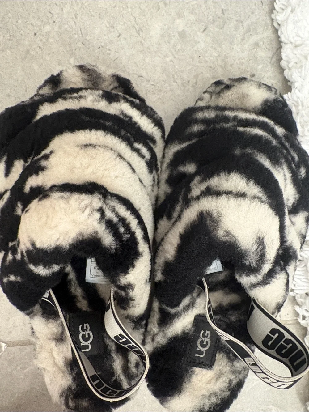 UGG Black and Ivory Faux Fur Crisscross Slide Sandals